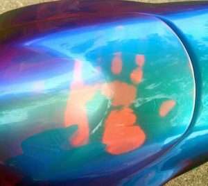 Temperature changing paint on Kameleon Super-Bike. John Haro's handprint on his thermochromic pigment painted motorcycle tank. Temperature changing kameleon!.