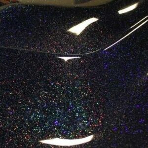 Black holographic metal flake on a car hood. Holographic flakes.